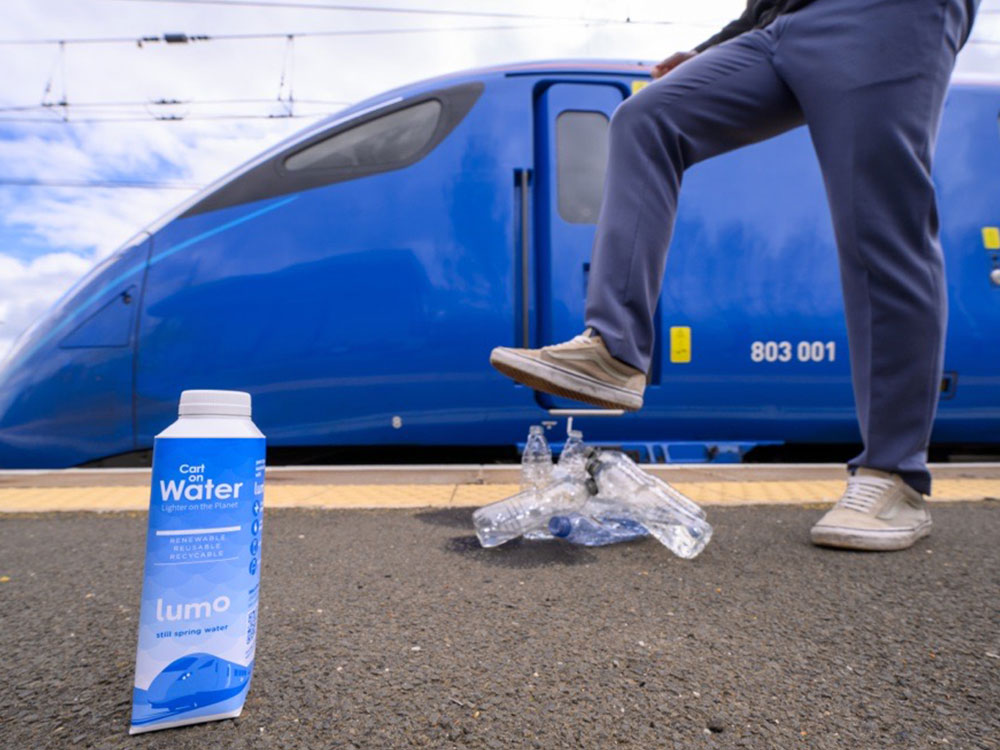 Image of a person stepping on a bottle of water in front of Lumo train