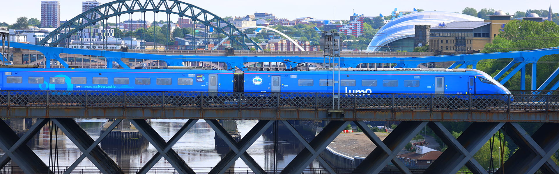 Lumo train passing through Tyne bridge