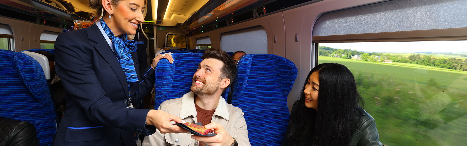 Lumo staff handing a snack to a passenger