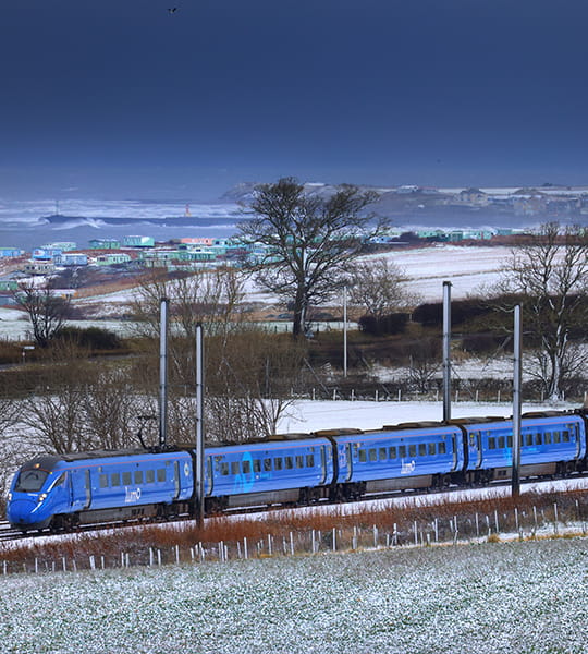 Lumo train passing through a field of snow