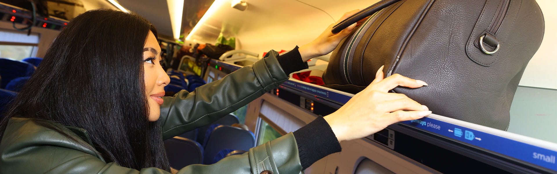 Customer storing luggage in overhead rack