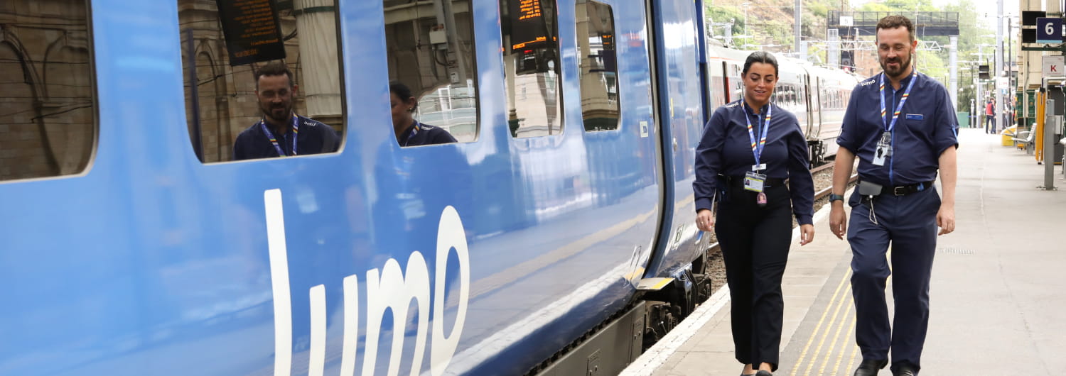 lumo train crew walking next to a lumo train