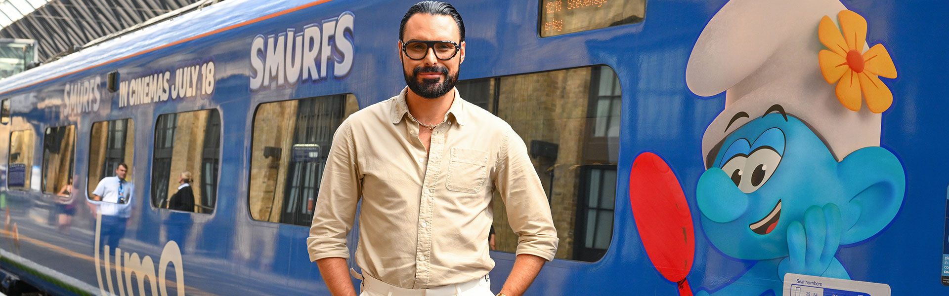 Rylan standing next to Lumo train