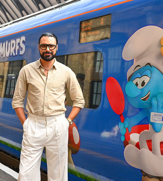 Rylan standing next to Lumo train