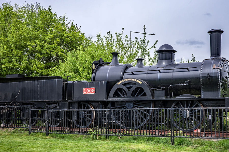 Replica of the Bloomer Class 2-2-2 1009 Wolverton steam locomotive in the grounds of Milton Keynes Museum