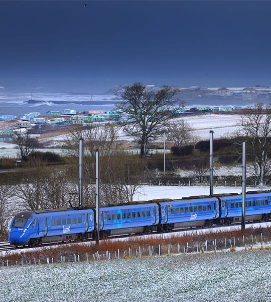 Lumo train passing through a field of snow