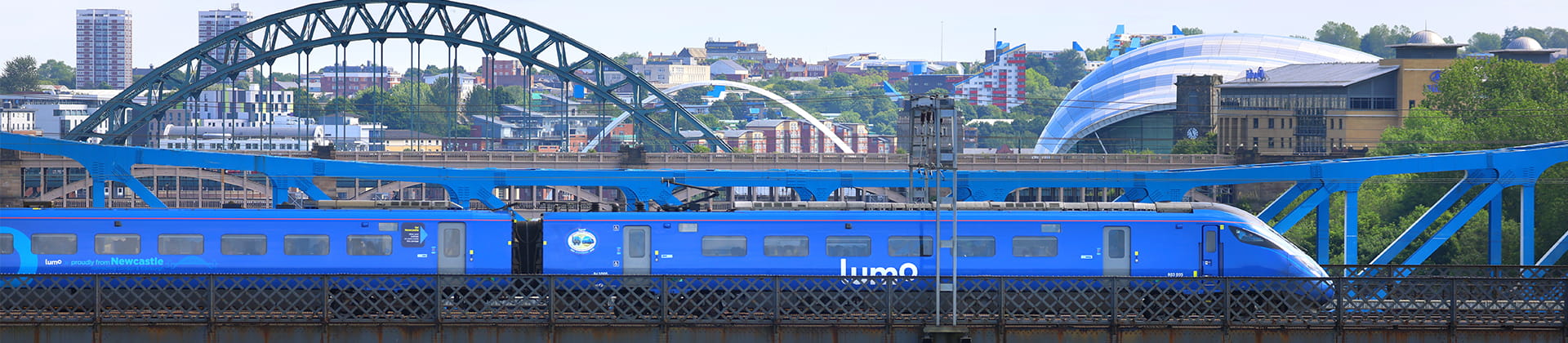 Lumo train crossing Tyne Bridge in Newcastle