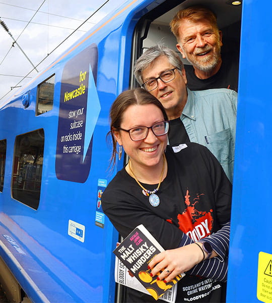 Authors Natalie Jayne Clark, Gordon Brown and Douglas Skelton boarding a Lumo train