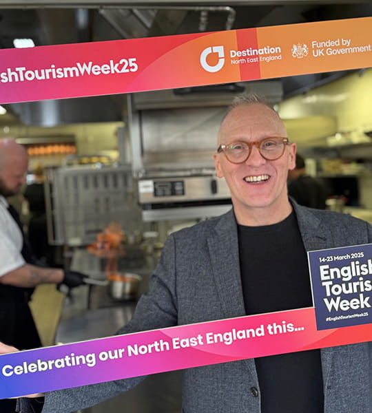 Alfie Joey, broadcast and event host, holding an English Tourism Week sign
