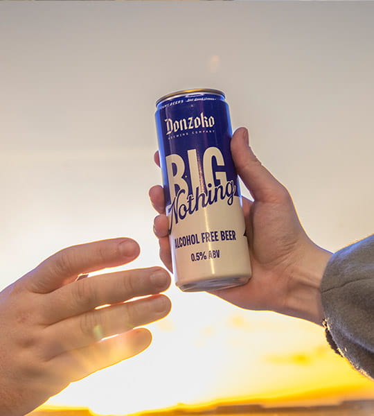 two hands holding the new low-calorie beer