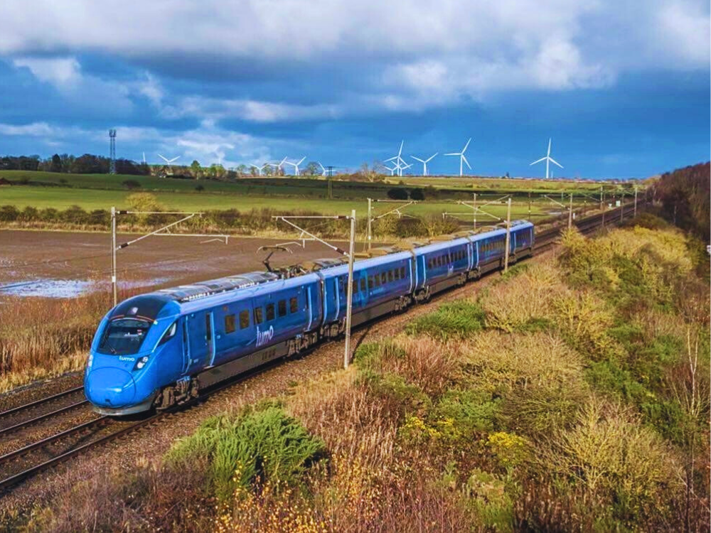 train on journey sustainability wind turbines