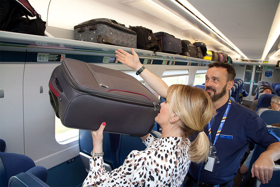 Customer leaving a holdall on the overhead rack